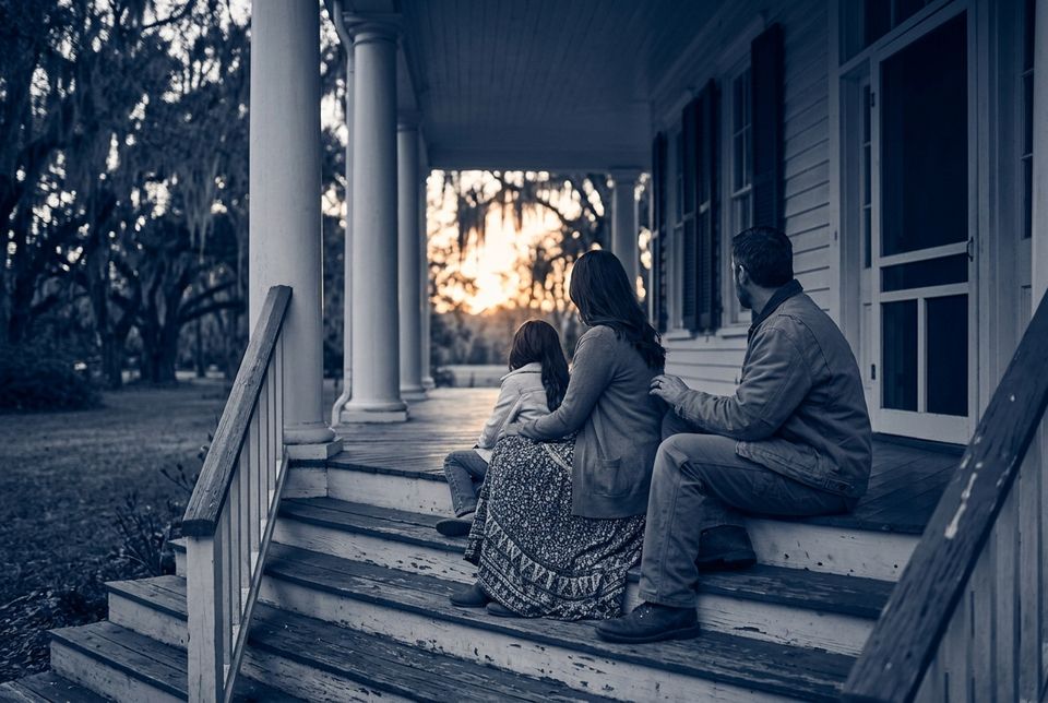 A family sitting together on porch steps