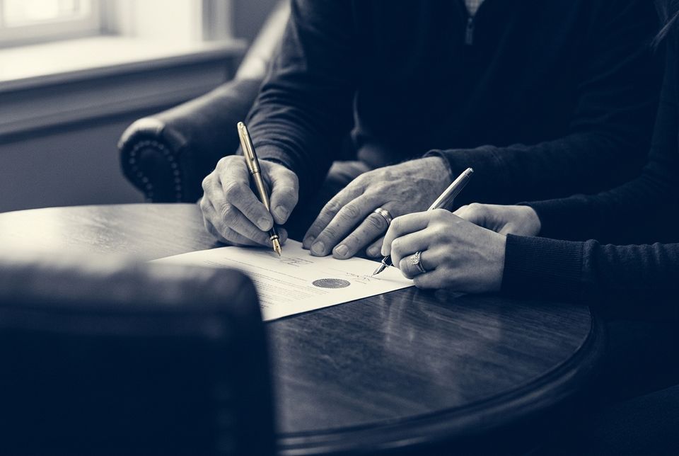 A couple signing a prenuptial agreement
